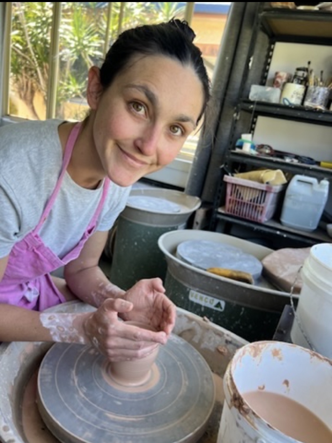 Fauve shaping clay on the pottery wheel